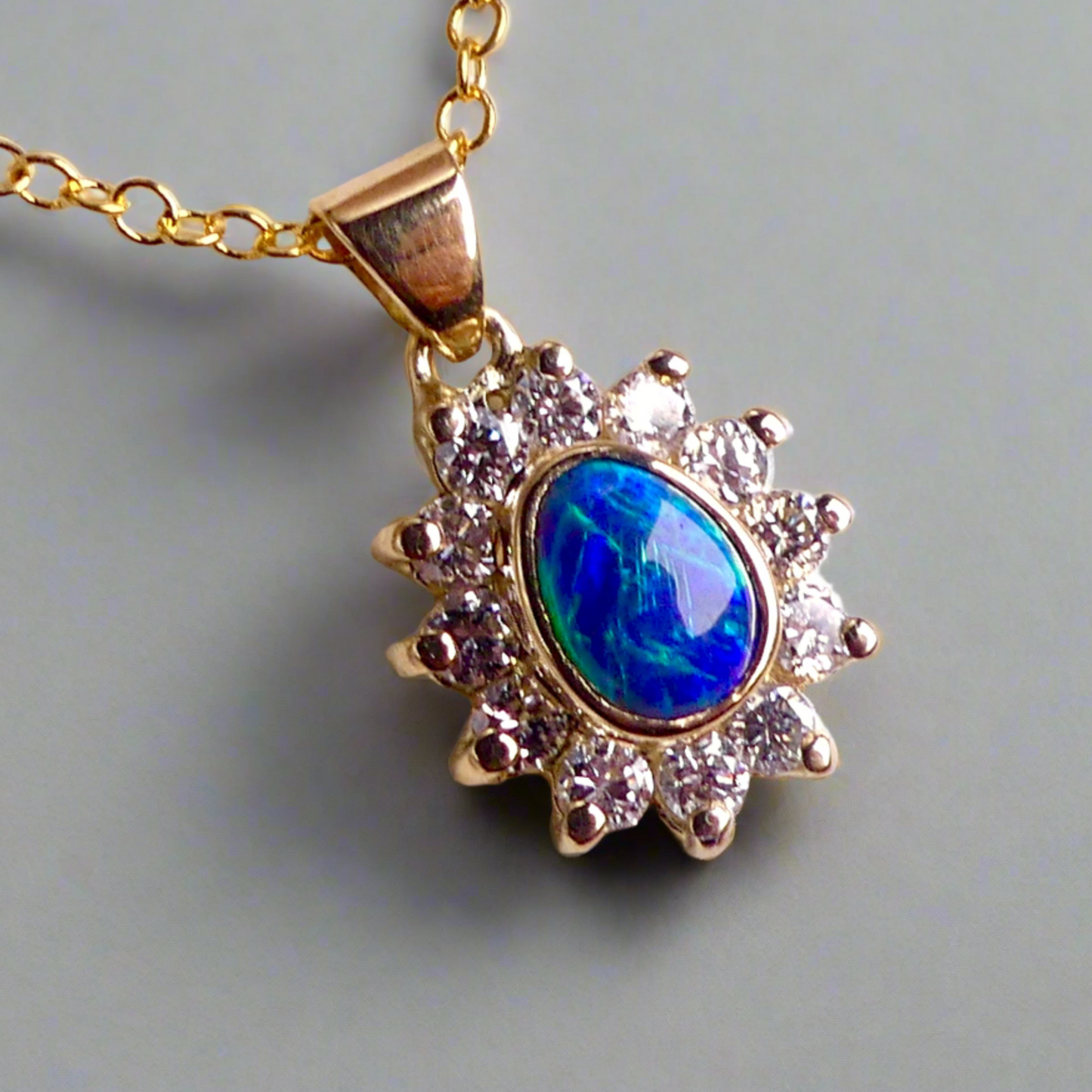 Vibrant sparkling 18K Yellow Gold Black Opal & Diamond Halo Pendant