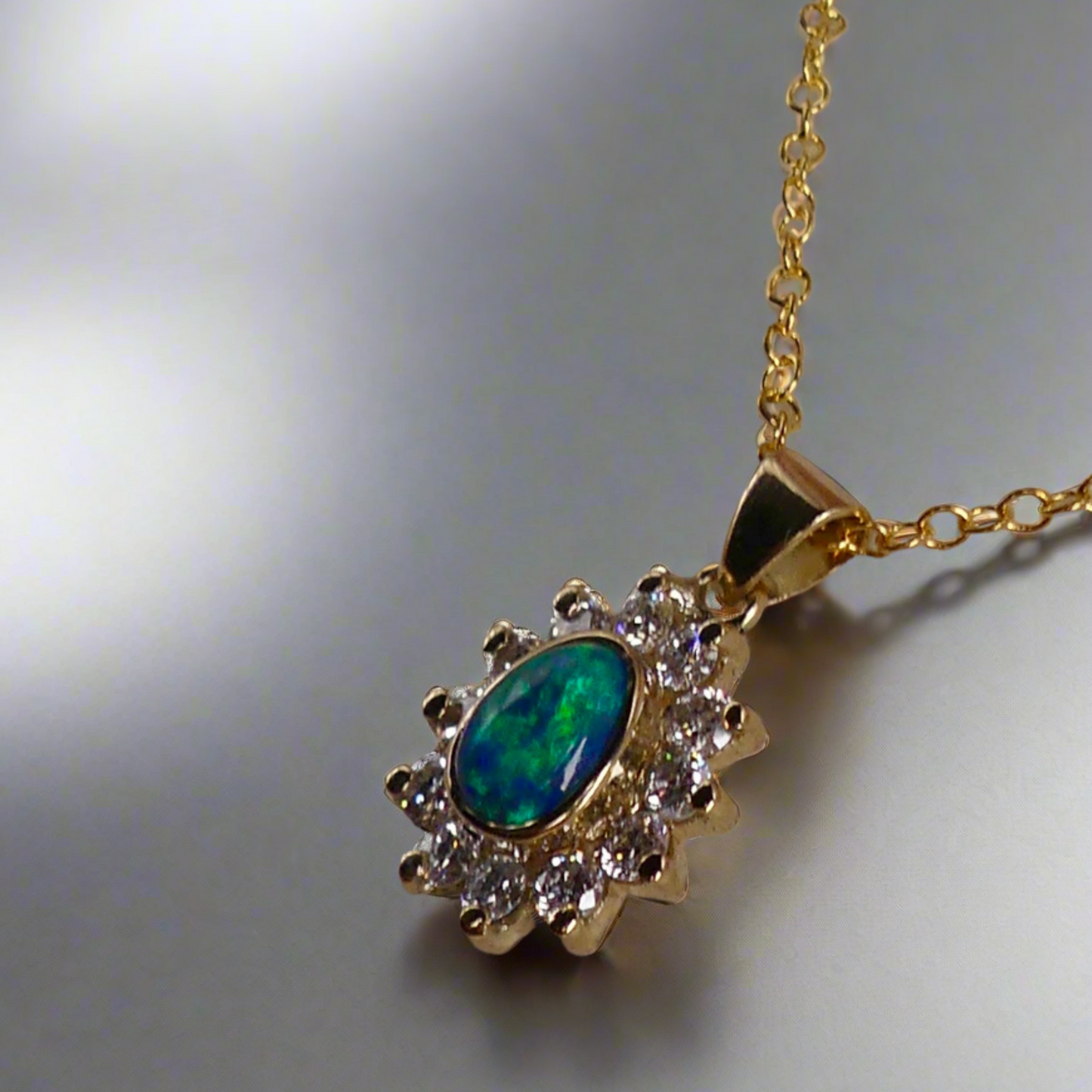 Vibrant sparkling 18K Yellow Gold Black Opal & Diamond Halo Pendant